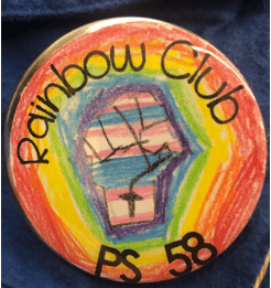 Elementary School Rainbow Club Pin showing a rainbow-colored, raised fist. (Lee County GSA)
